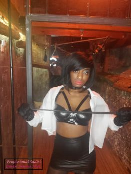 Queen Naomi NYC is prepared to discipline her subjects in her dungeon. She is holding her single tail in her hand and is ready to deliver pain.